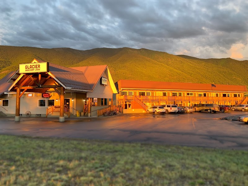 Lodge exterior at Glacier National Park during golden hour with mountain backdrop.