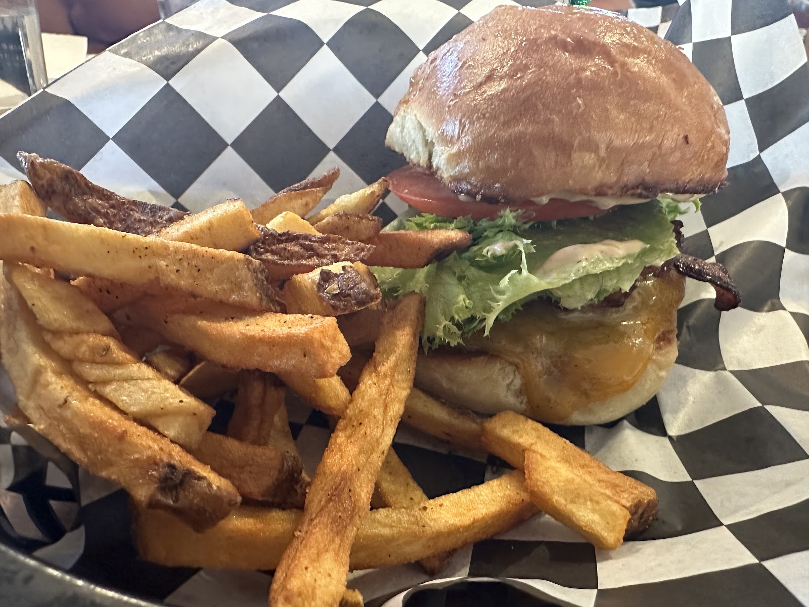 Juicy burger with lettuce and tomato and a side of fries served at Mudman Burgers - Whitefish in Glacier National Park.