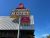 Motel sign along a roadside in Yellowstone National Park under a clear blue sky.