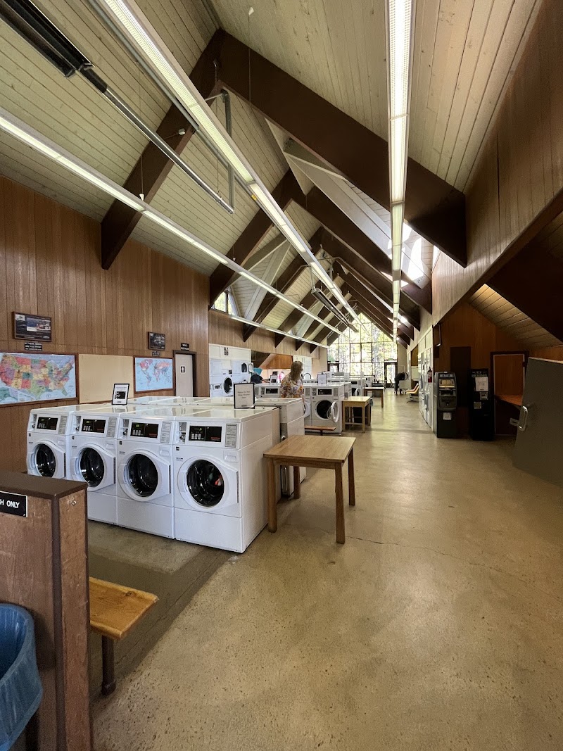Canyon Campground laundry facility in Yellowstone National Park with row of washing machines.