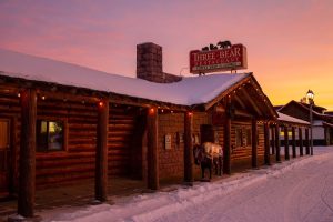 Rustic exterior storefront featuring bear-themed sign and wooden siding