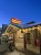 Restaurant exterior at Mammoth Hot Springs, Yellowstone National Park, with stone walls, glowing string lights, and snow on the roof.