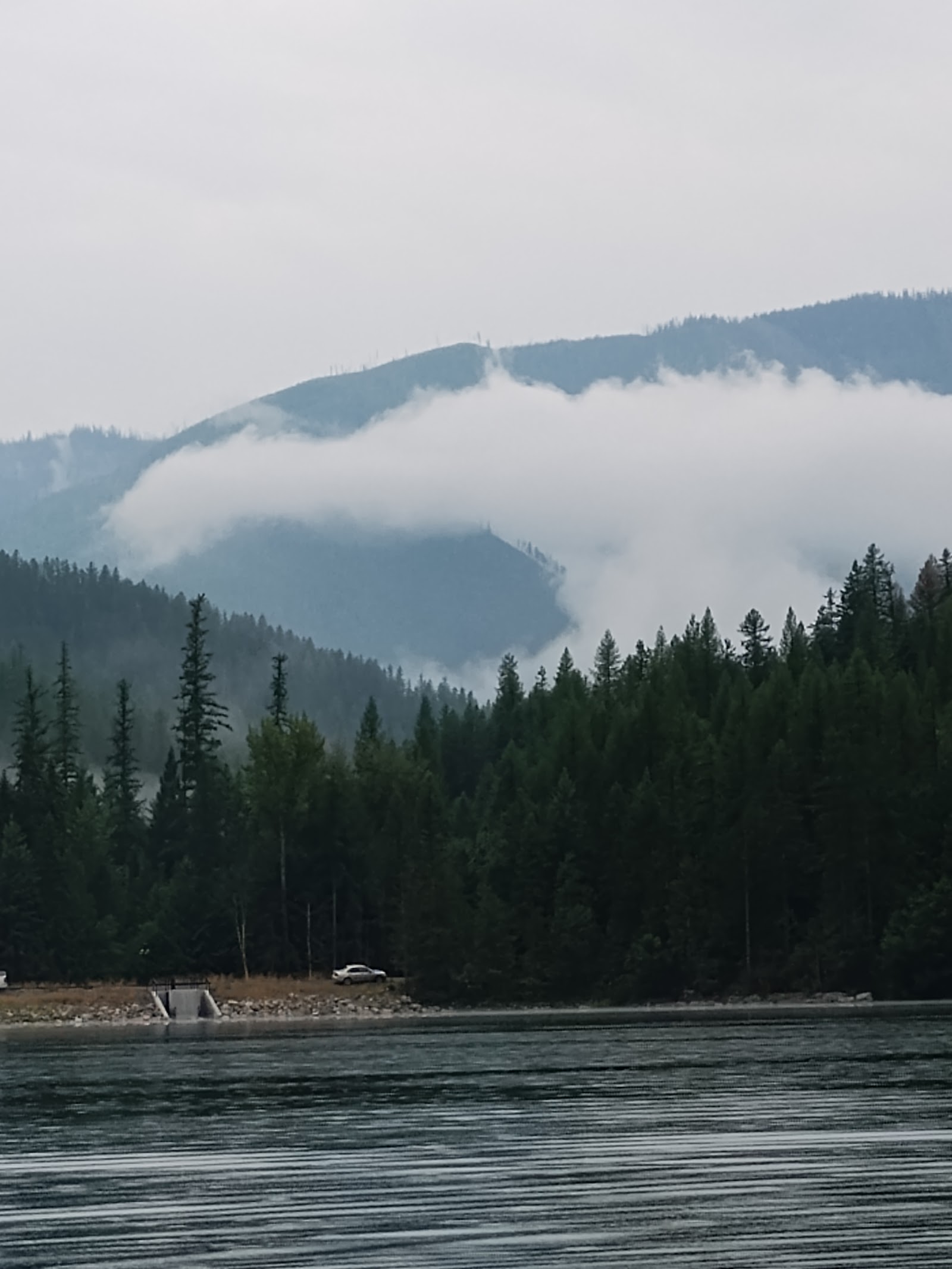 North Lion Lake Picnic Site in Glacier National Park, set along the lake with evergreen forests and distant mountains.