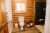 Log cabin bathroom in a Glacier National Park lodging unit with wooden walls and a compact toilet.