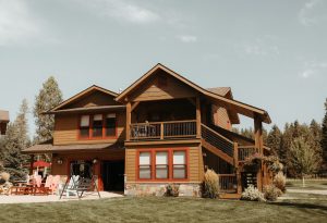 Lodge at a Glacier National Park resort with a two-story wooden exterior and wraparound deck.