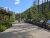 Visitor center plaza at Glacier National Park with informational boards along a stone wall and flagpoles.