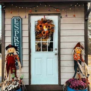 Glacier National Park storefront for an espresso cafe with a light blue door and autumn wreath.