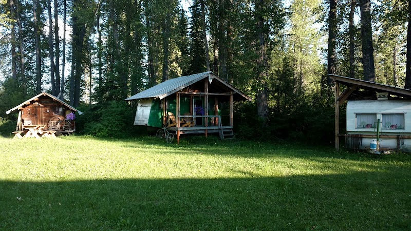 North Fork Hostel at Glacier National Park sits among rustic cabins in a forest clearing.