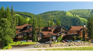 Kandahar Lodge at Glacier National Park's Whitefish Mountain Resort, a rustic alpine lodge with red-brown roofs.