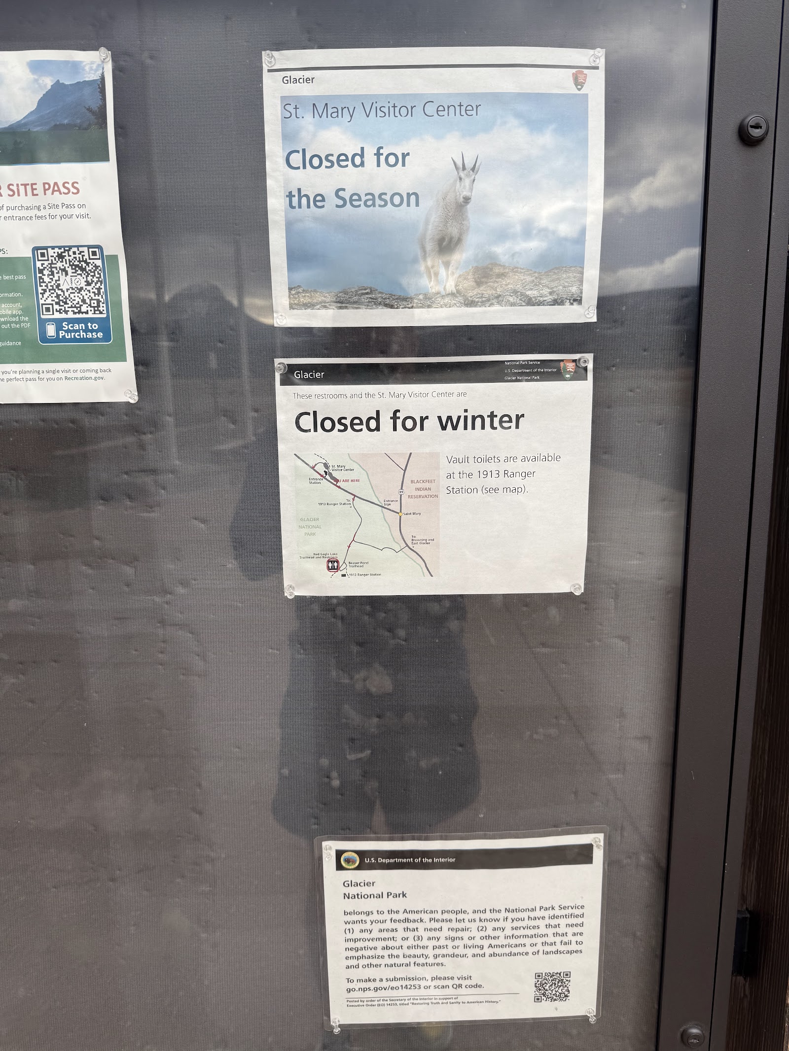 Glacier National Park bulletin board with posters showing Closed for the Season, Closed for winter, a map, and a goat image.