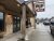 Cafe storefront along a wet sidewalk in Glacier National Park, with a rustic exterior and warm lights.