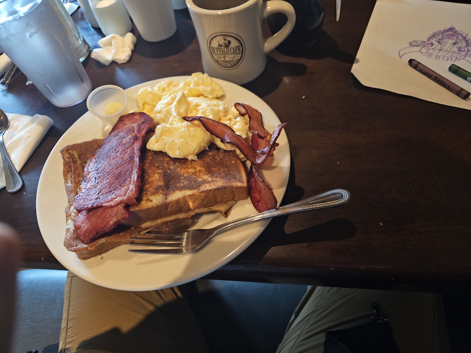 Breakfast plate with bacon, eggs and toast at a Glacier National Park cafe, early morning light.