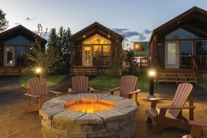 Exterior view of a rustic lodge-style building with a wooden facade and natural surroundings