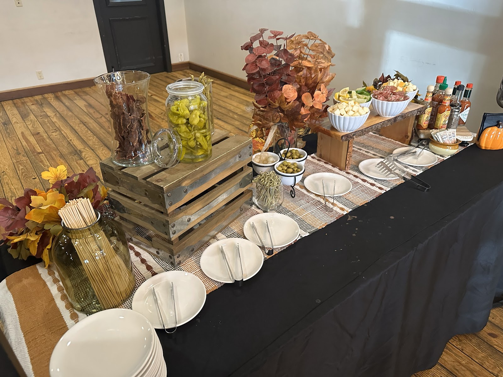 Buffet setup in a lodge dining room inside Glacier National Park, with jars of snacks and autumn decor.