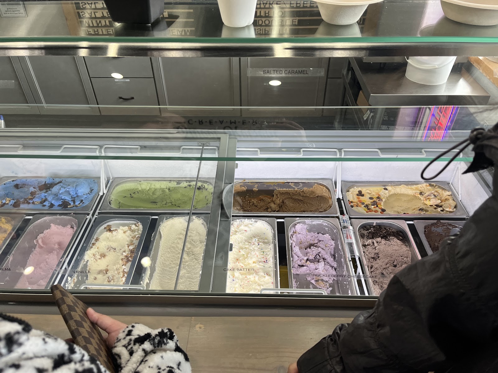 Inside a Glacier National Park ice cream shop, a glass-front display case presents colorful flavors.
