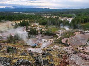 Exterior view of a rustic storefront with trailhead signs and wooden siding