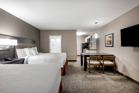Contemporary hotel room with two queen beds and kitchenette near Glacier National Park in the Whitefish region.