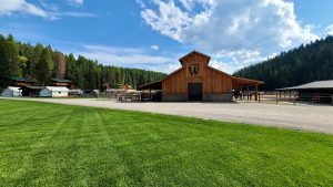 Wooden ranch building with a large sign at Glacier National Park guest ranch.