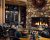 Grouse Mountain Lodge lobby in Glacier National Park, a stone-and-fireplace lounge with rustic seating and warm lighting.