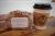 Banana bread and a takeaway coffee cup on a wooden table at a Yellowstone National Park café.