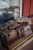 Assorted loaf breads wrapped in plastic on a metal basket display outside a shop in Yellowstone National Park.