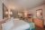 Two queen beds in a lodge-style Yellowstone National Park guest room with plaid runners.