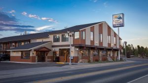 Rustic lodge exterior with wooden siding and stone accents, inviting entrance