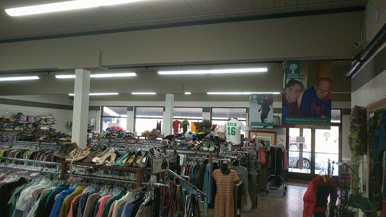 Thrift shop interior at Glacier National Park in the Whitefish area, with clothing racks and shelves.