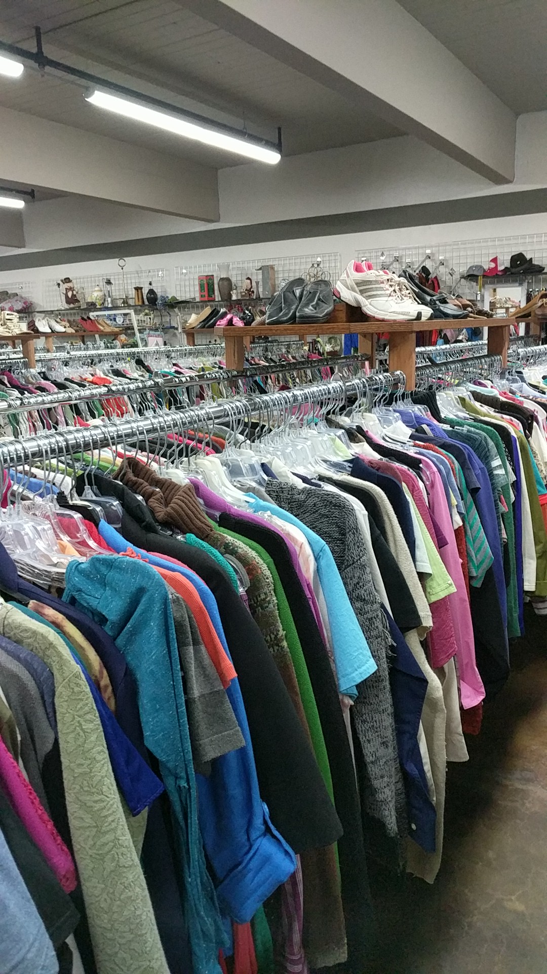 Brightly colored shirts and jackets line racks inside Whitefish Thrift in Glacier National Park.