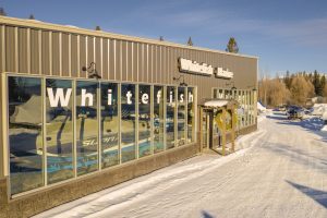 Glacier National Park gift shop storefront along a snow-covered access road in winter.