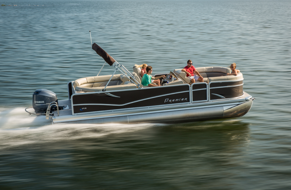 Pontoon boat with passengers cruising Whitefish Lake near Whitefish, within Glacier National Park area.