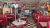 Retro diner interior with red vinyl booths and a black-and-white checkered floor in Yellowstone National Park.