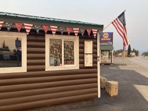 Exterior view of a cafe storefront with a striped awning and a chalkboard sign