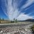 Pass Creek day use area in Glacier National Park beside a rocky riverbank and expansive blue sky.