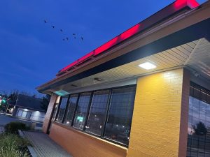 Exterior of a Mexican restaurant near Acadia National Park under blue twilight sky, neon lighting along the roofline.