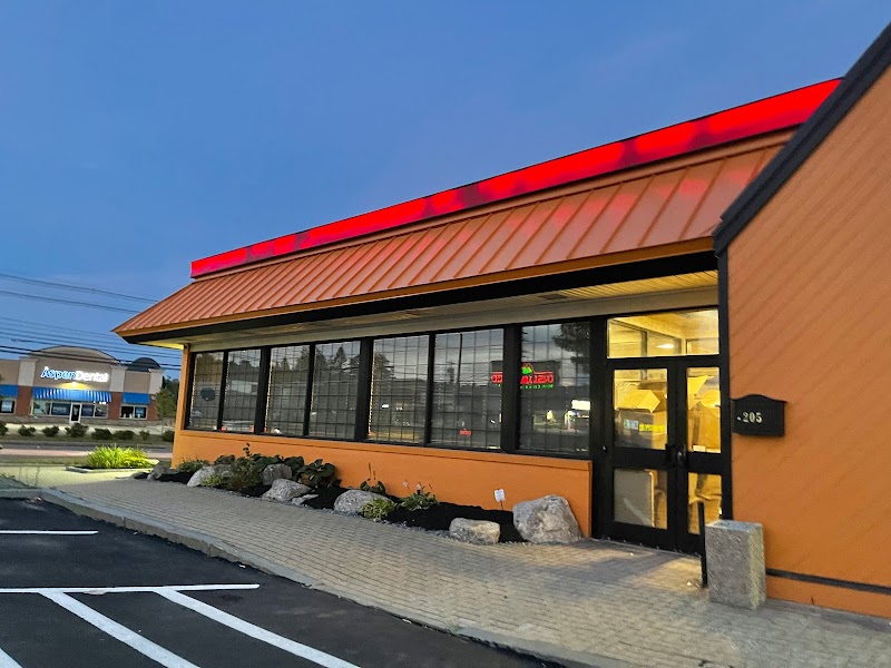 Casa Jalisco restaurant exterior in Acadia National Park, orange building with a red roof and large windows.