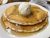 Breakfast pancakes with butter and maple syrup served on a plate in Acadia National Park.