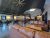 Cozy interior of an indoor brewery seating area inside Acadia National Park with leather couches and communal tables.