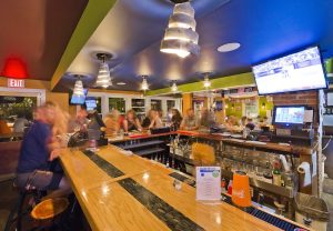 Cafe interior at Acadia National Park, a lively bar and dining spot with a long wooden counter.