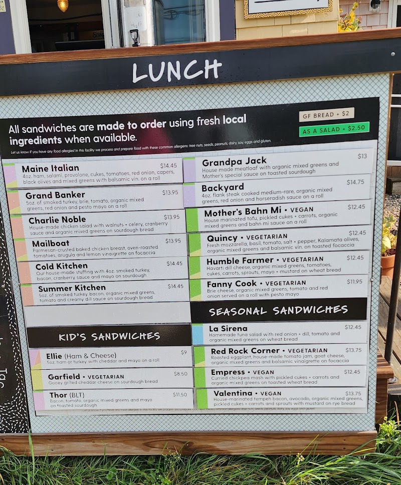 Outdoor menu board under a lunch sign at Acadia National Park features a variety of sandwiches, kid’s items, and seasonal options.