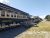 Downeast Scenic Railroad cars at a platform along Acadia National Park, with a green railcar and wooden walkway