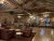 Lake Lodge lobby interior at Yellowstone National Park, featuring rustic timber beams and leather seating.