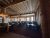 Interior dining hall of a rustic lodge in Yellowstone National Park, with log pillars, wooden beams, and many round tables.