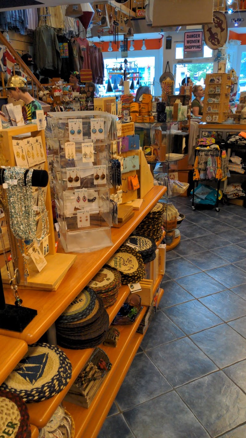 Gift shop interior at Little Village Gifts in Acadia National Park, filled with hats, jewelry, and souvenirs along sunny lighted shelves.