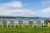Lawn seating along the water at Acadia National Park, Adirondack chairs facing a calm bay from a coastal lodge lawn.