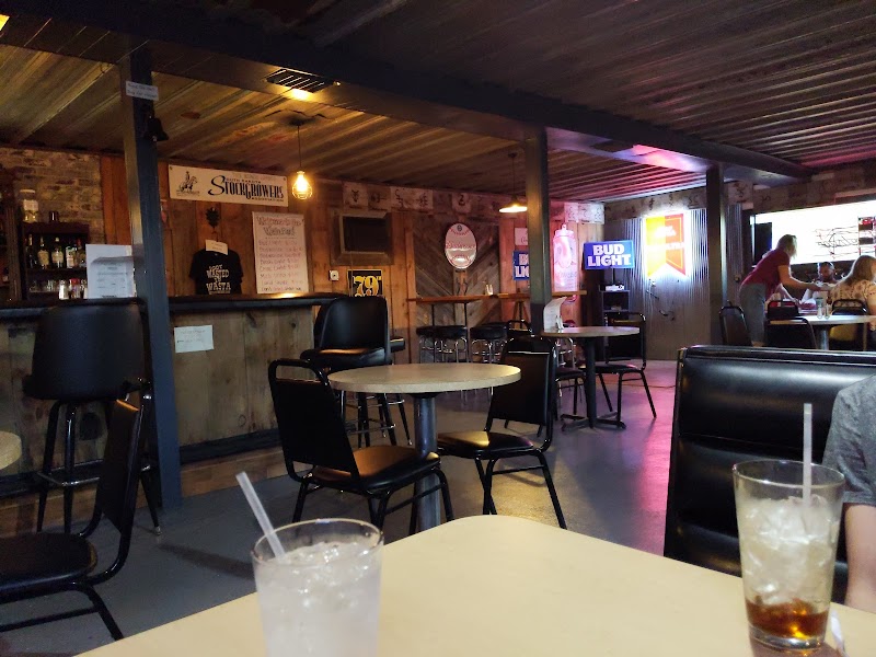 Interior of a rustic bar in the Wasta area of Badlands National Park, wood-paneled walls and warm lighting.