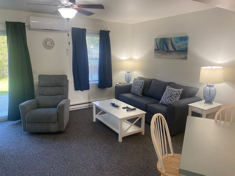 Cozy lodge living room with sofa, recliner and blue accents in Acadia National Park lodging.