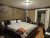 Cozy lodge bedroom in Yellowstone National Park with a large bed, bear decor, and warm lighting.