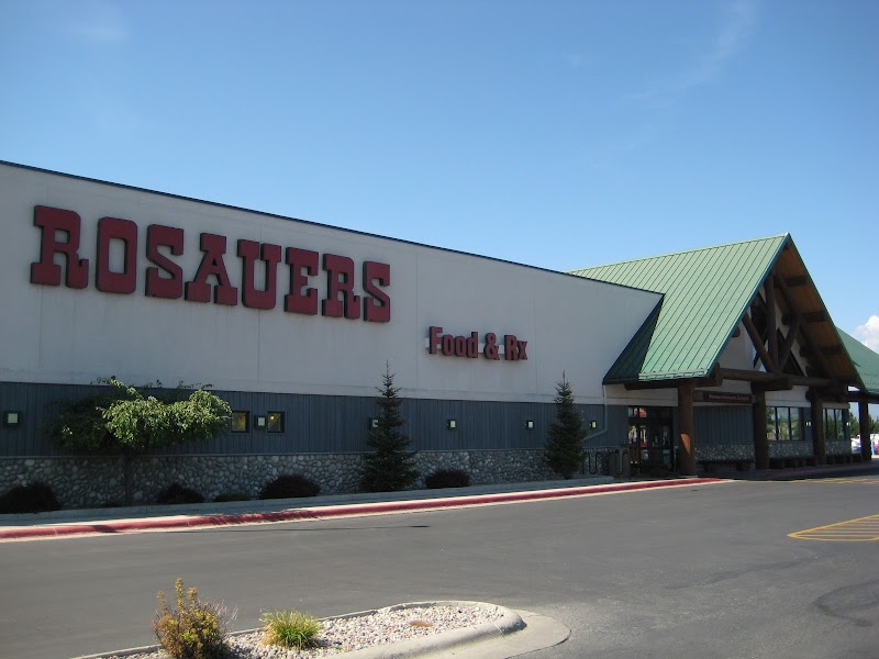 Shops and services near Glacier National Park west entrance with green peaked roofs and stone facade storefronts in West Glacier, Montana
