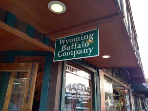 Buffalo-themed storefront storefront under a wooden overhang in Yellowstone National Park.